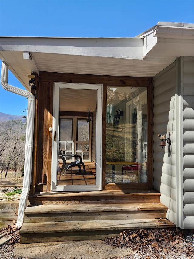 doorway to property with faux log siding