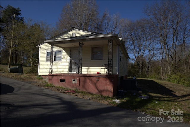 view of home's exterior featuring crawl space and a porch