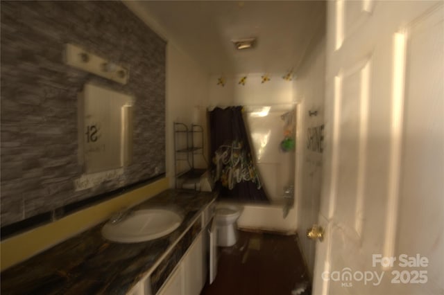 bathroom featuring toilet, shower / washtub combination, and vanity