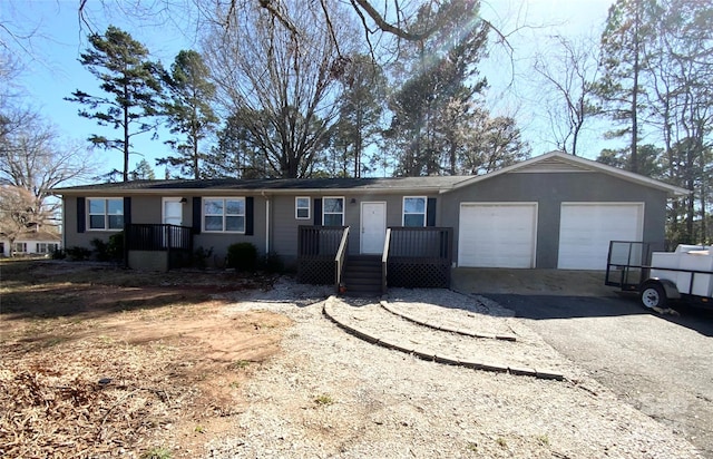 ranch-style home with a garage and driveway