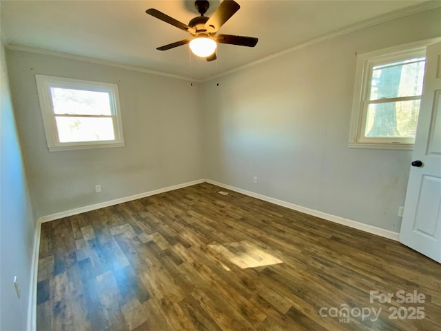 unfurnished room featuring dark wood-type flooring, a ceiling fan, baseboards, and ornamental molding