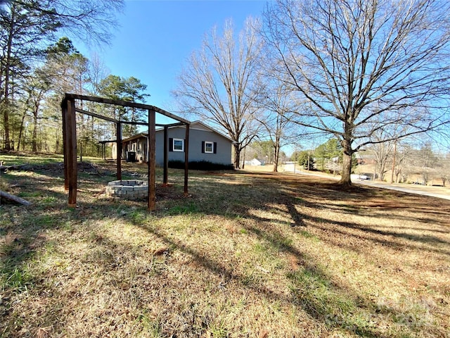 view of yard with an outdoor fire pit