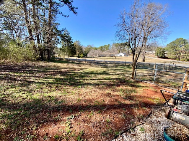 view of yard featuring a rural view and fence