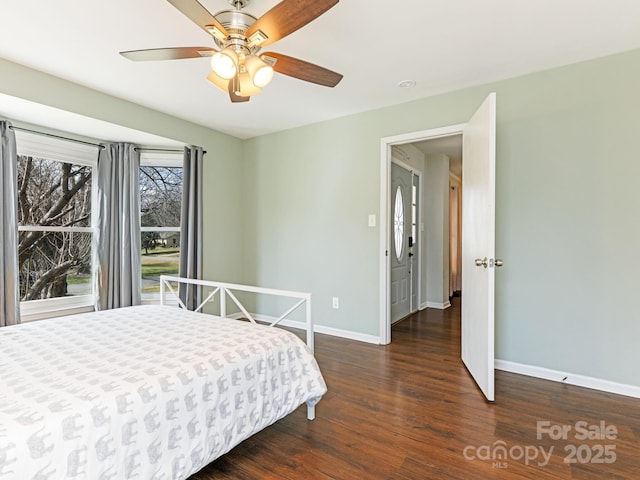 bedroom with baseboards, wood finished floors, and a ceiling fan