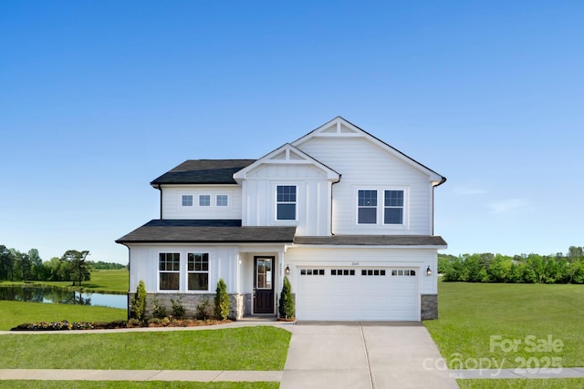 view of front of property featuring board and batten siding, a front yard, a garage, stone siding, and driveway