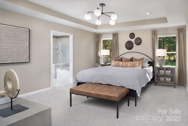 bedroom featuring a chandelier, light colored carpet, baseboards, and a tray ceiling