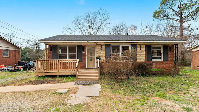 view of front of house featuring brick siding and covered porch