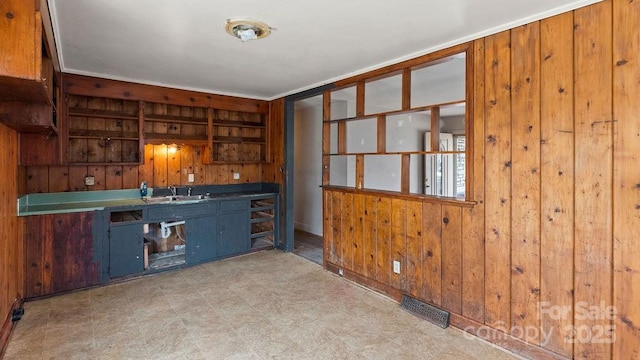 bar with visible vents, wood walls, and light floors