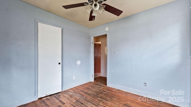 unfurnished bedroom featuring baseboards, wood finished floors, and a ceiling fan