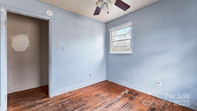 spare room with a ceiling fan, baseboards, and wood finished floors