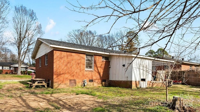 view of home's exterior featuring crawl space and brick siding