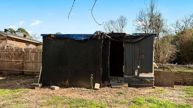 view of outbuilding featuring fence