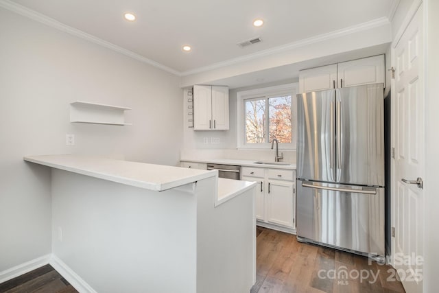 kitchen featuring visible vents, a sink, open shelves, dark wood finished floors, and appliances with stainless steel finishes