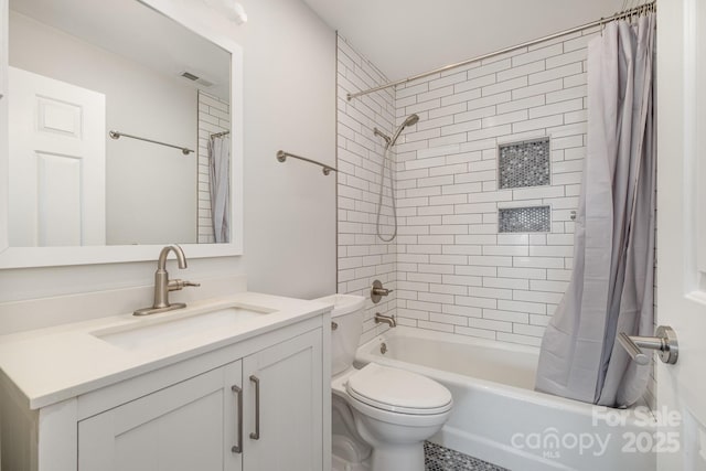 full bath with visible vents, shower / tub combo, toilet, and vanity