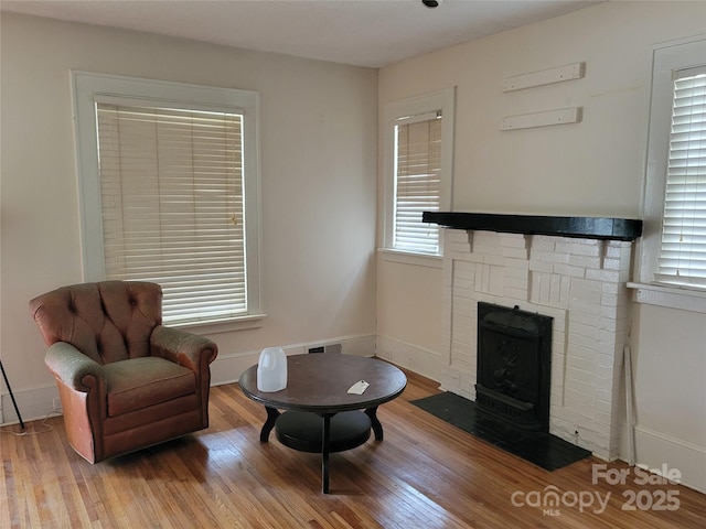 sitting room featuring baseboards and wood finished floors