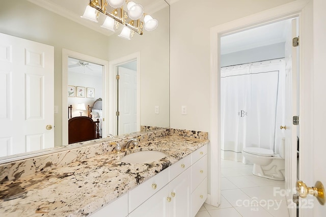 bathroom with toilet, ornamental molding, vanity, and tile patterned flooring