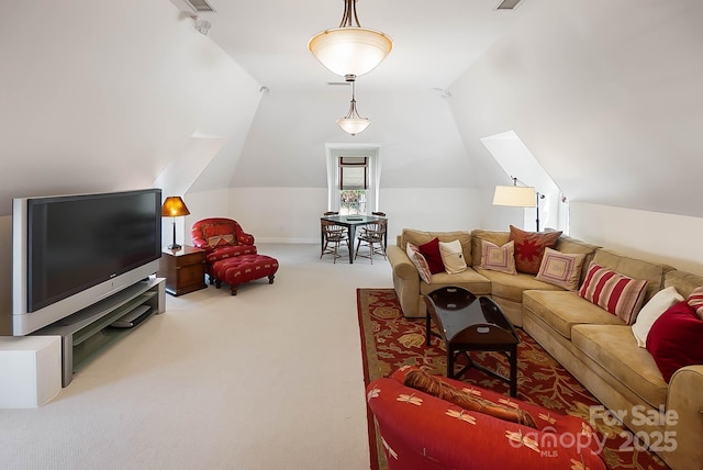 living area featuring visible vents, carpet, and vaulted ceiling