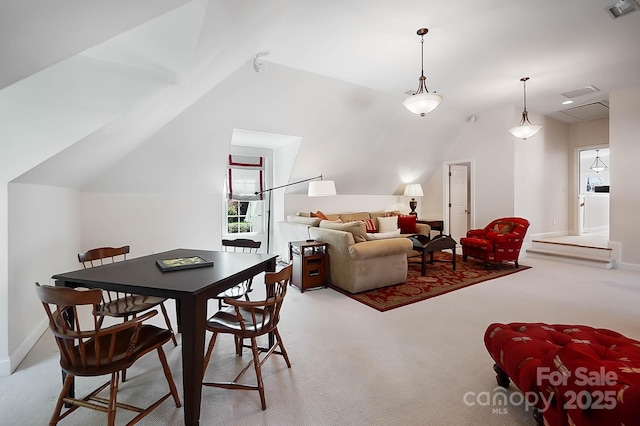 dining area featuring vaulted ceiling, carpet, visible vents, and baseboards