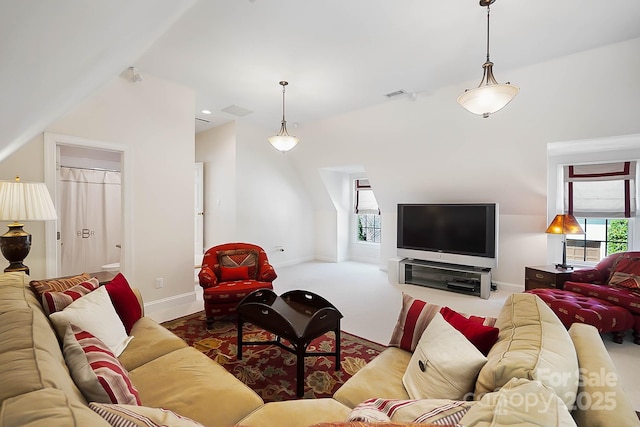 carpeted living area featuring visible vents and baseboards