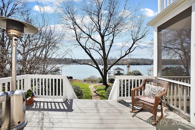 wooden terrace featuring a water view