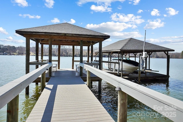 view of dock featuring a water view and boat lift