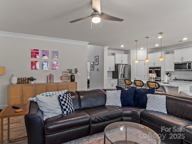 living room featuring recessed lighting, wood finished floors, and ornamental molding