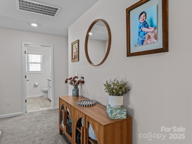 hall with visible vents, recessed lighting, baseboards, and carpet