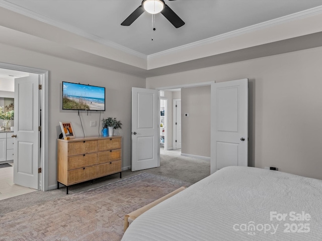 carpeted bedroom featuring connected bathroom, baseboards, a ceiling fan, and crown molding