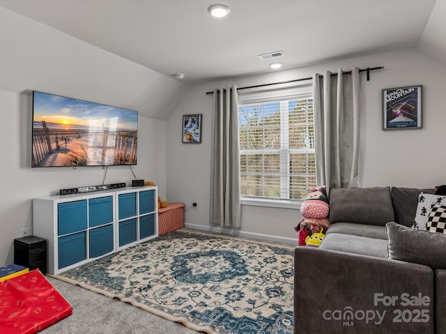 carpeted living area with visible vents, baseboards, and vaulted ceiling