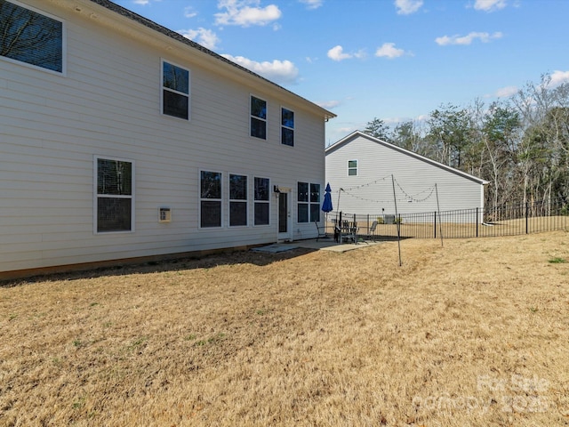 rear view of house with a yard, a patio, and fence