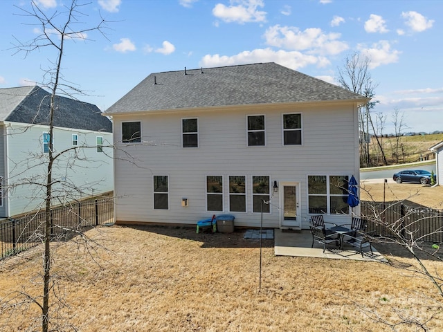 back of house with a patio area, fence, and a shingled roof