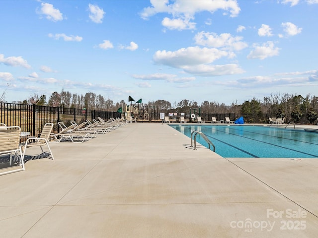 community pool featuring a patio and fence