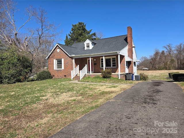 cape cod house with a porch, a chimney, a front lawn, crawl space, and brick siding