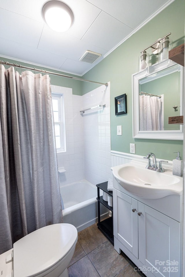 full bathroom with vanity, visible vents, ornamental molding, shower / bath combo with shower curtain, and toilet