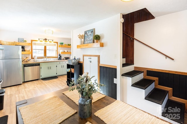 dining space with stairway and light wood-type flooring