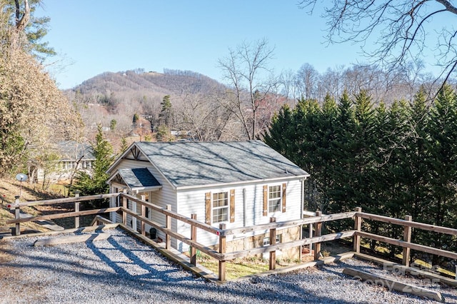 exterior space featuring a mountain view and a wooded view