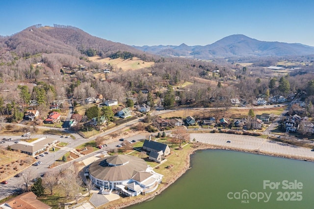 birds eye view of property featuring a water and mountain view