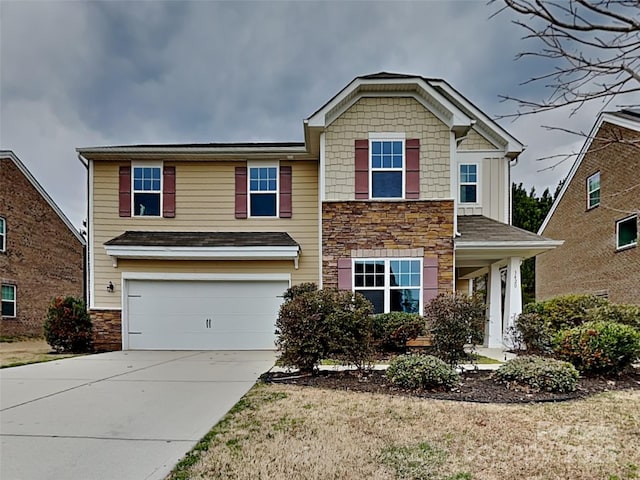 view of front facade featuring an attached garage, stone siding, and driveway