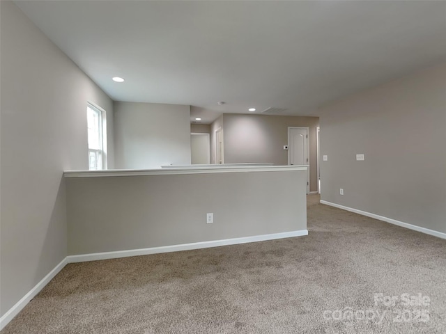 unfurnished room featuring carpet flooring, recessed lighting, and baseboards