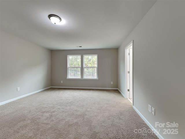 unfurnished room featuring visible vents, baseboards, and carpet