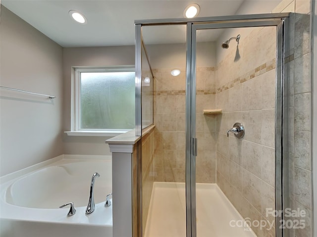 full bathroom with recessed lighting, a stall shower, and a garden tub