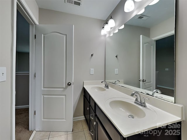 full bathroom with tile patterned floors, double vanity, visible vents, and a sink