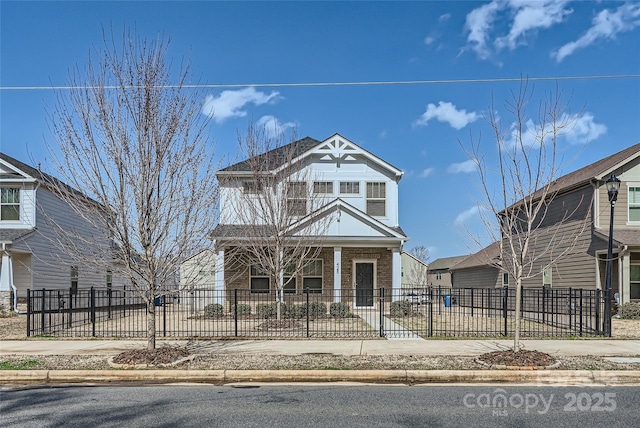 view of front facade featuring concrete driveway and a fenced front yard