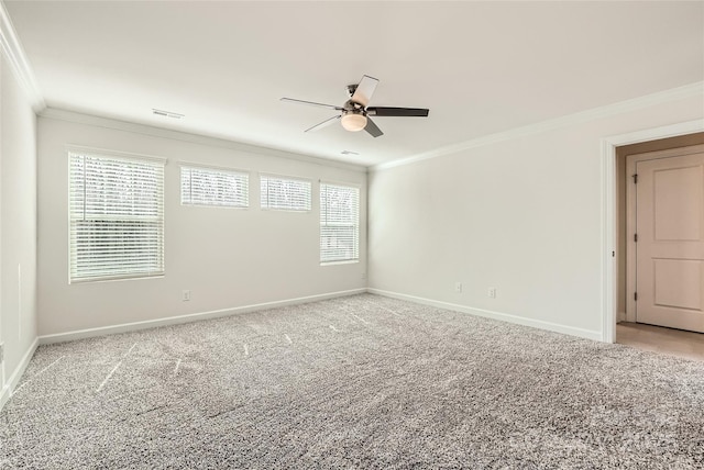 spare room featuring visible vents, crown molding, baseboards, ceiling fan, and light colored carpet