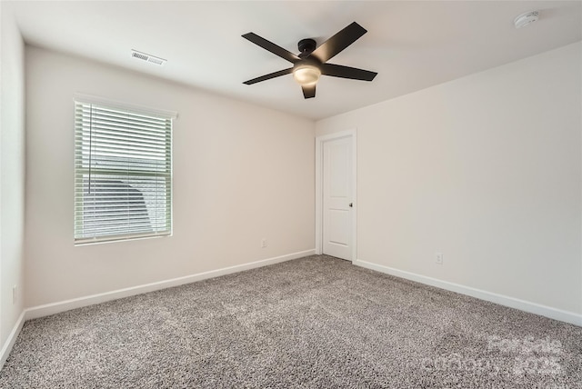 empty room with visible vents, baseboards, ceiling fan, and carpet flooring