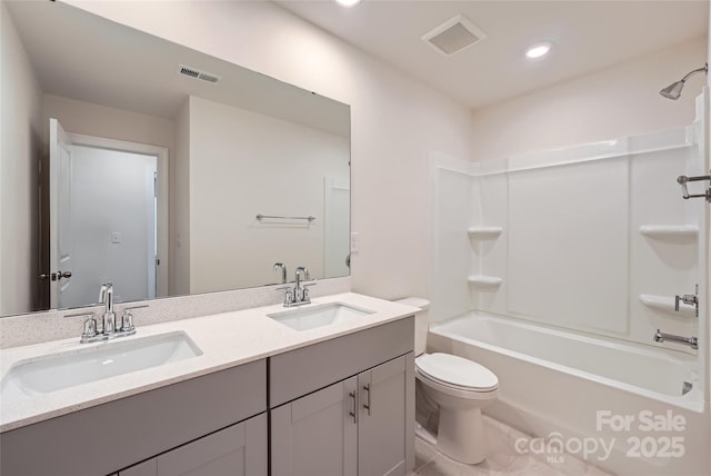 bathroom featuring toilet, visible vents, and a sink