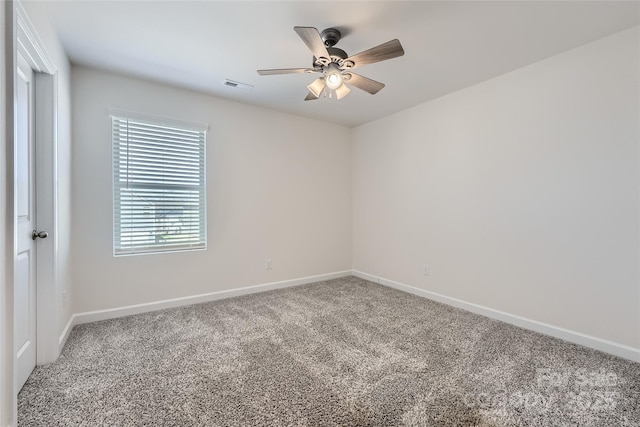 carpeted empty room featuring visible vents, baseboards, and a ceiling fan