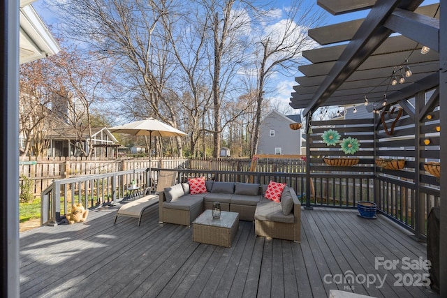 wooden terrace featuring an outdoor living space and fence