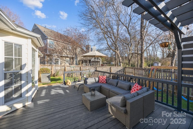 deck with an outdoor living space and fence