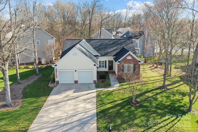 view of front of house featuring driveway, brick siding, roof with shingles, and a front yard